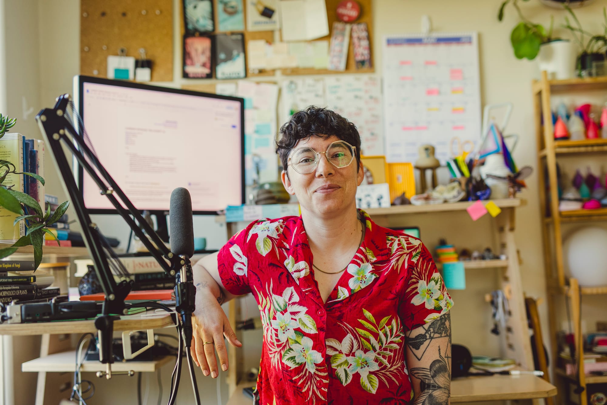 A photo of a person (me) wearing a red Hawaiian shirt sitting in front of a cluttered desk.