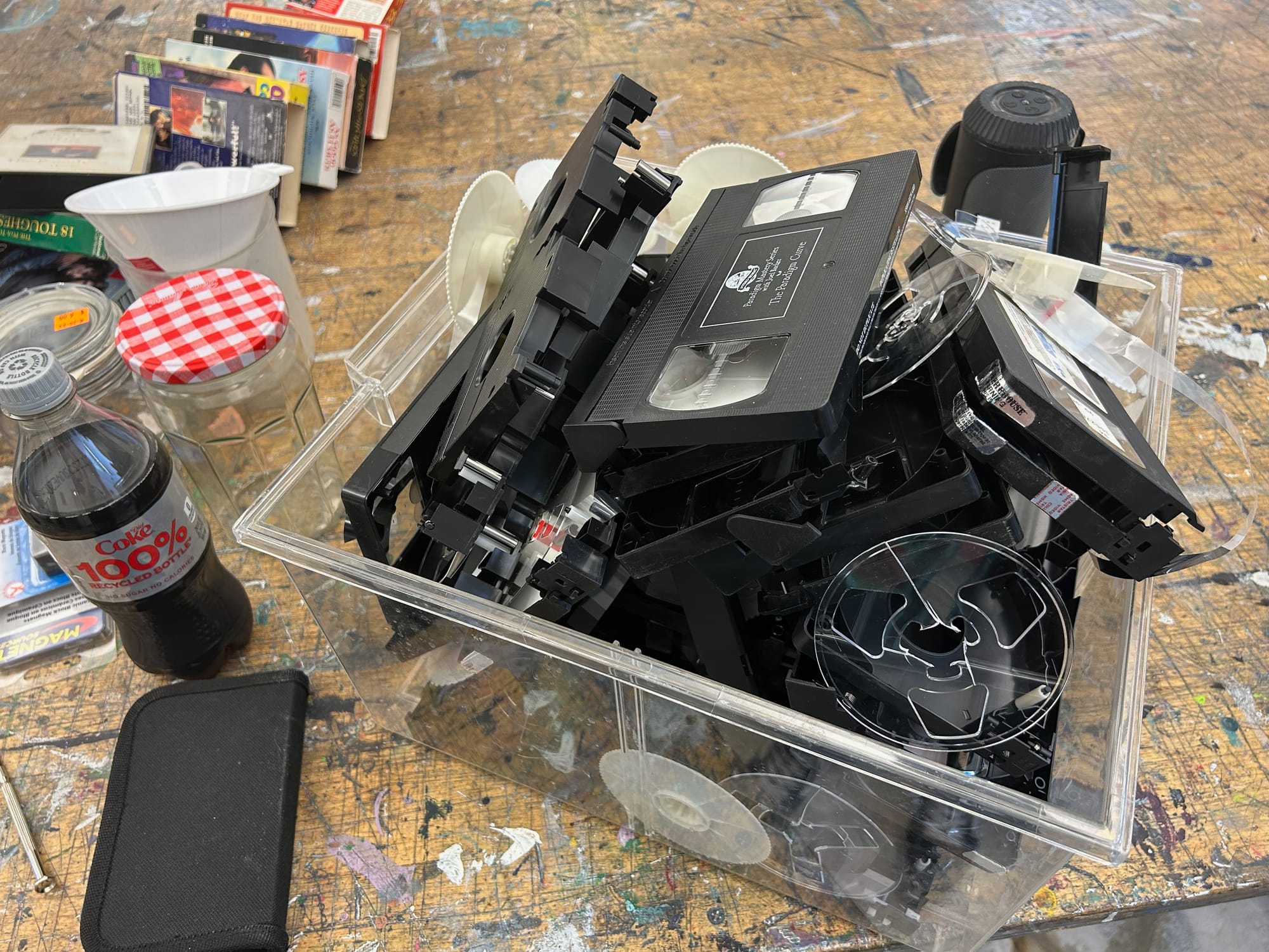 a plastic bin full of disassembled VHS tapes