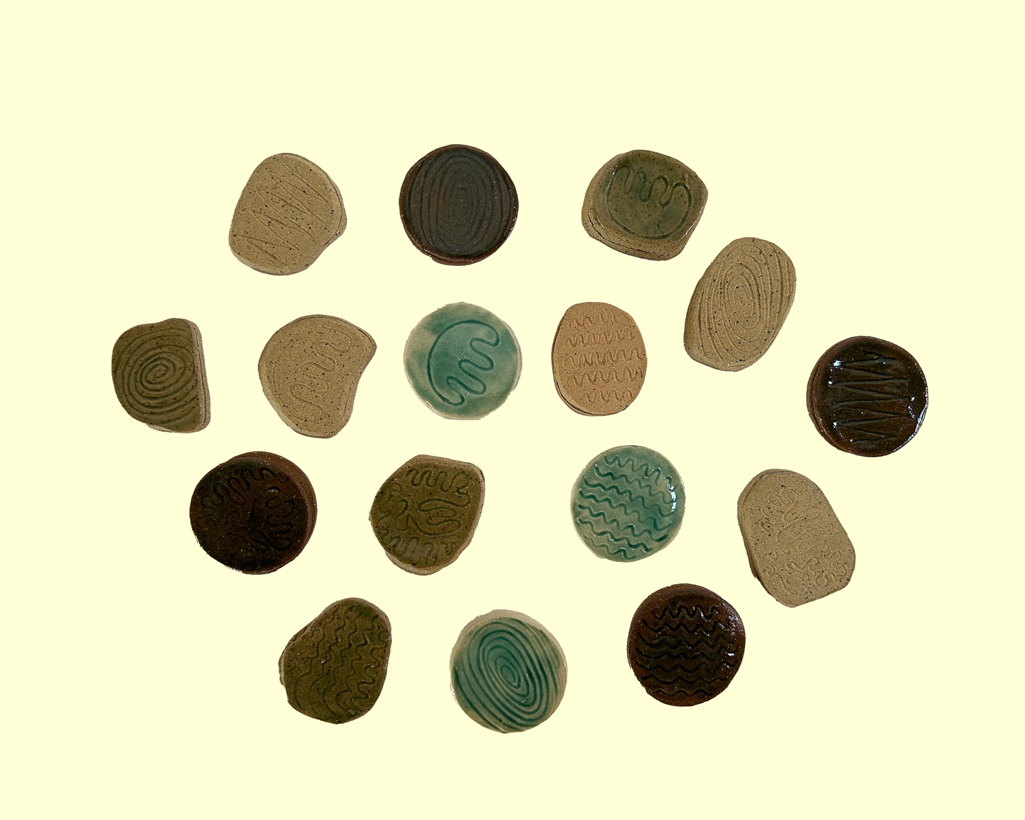 a series of small stones with little patterns drawn on them in all different colors